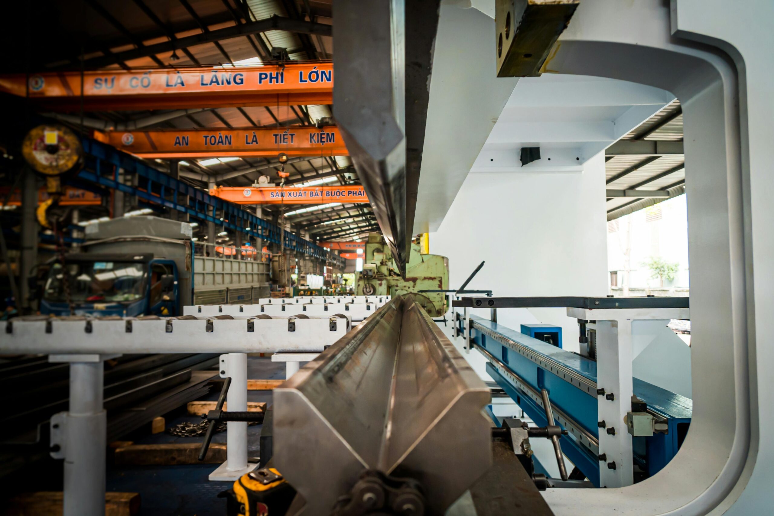 Interior view of an industrial building featuring machinery and metal conveyor systems.